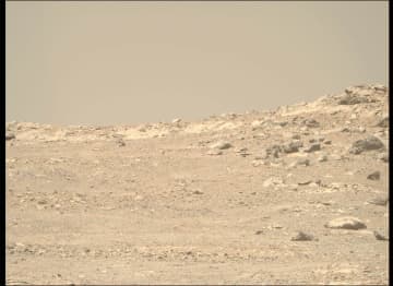 2025年9月10日の火星の風景：塵に霞む遠景と風化した岩々