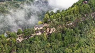 絶壁を包む霧に浮かび上がるトゥチャ族伝統集落　湖北省