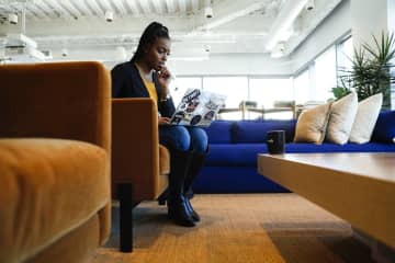 Shaniqua Davis, who runs a new business Noirefy, which helps companies look for job candidates from diverse backgrounds, gets some work done on her laptop Jan. 6, 2020, at a WeWork co-working space in Chicago. - Jose M. Osorio/Chicago Tribune/TNS