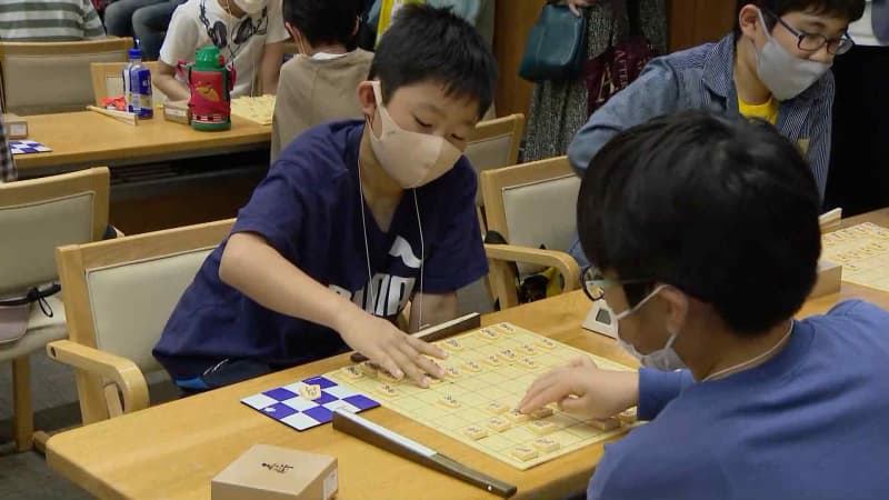 Elementary and junior high school students compete hotly on the board while being watched by professionals, "Children's Shogi Meijin Tournament"