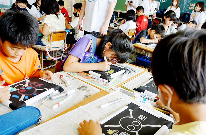 A special lesson on the popular manga ONE PIECE excites children at an elementary school in Hasuda.