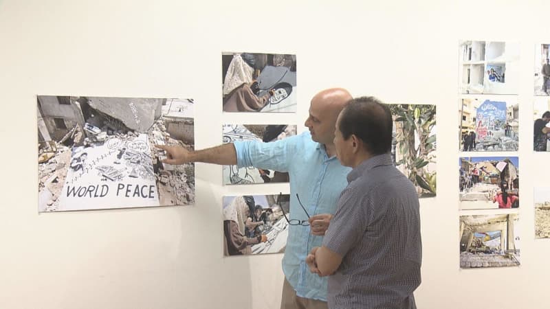 Barefoot Gen illustration on rubble Syrian artist appeals for peace Panel exhibition in Hiroshima