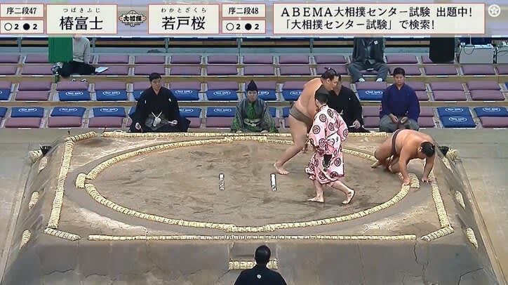A sumo wrestler who collapses unnaturally and immediately rushes to his feet. ``The heart of compassion is beautiful.'' One frame in the ring resonates