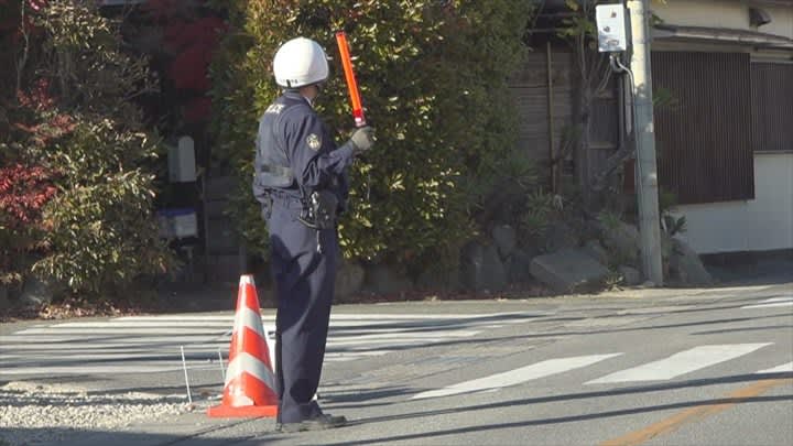 A car and a bicycle collide at an intersection with a traffic light, and the cyclist, a woman in her 70s, is unconscious and in critical condition