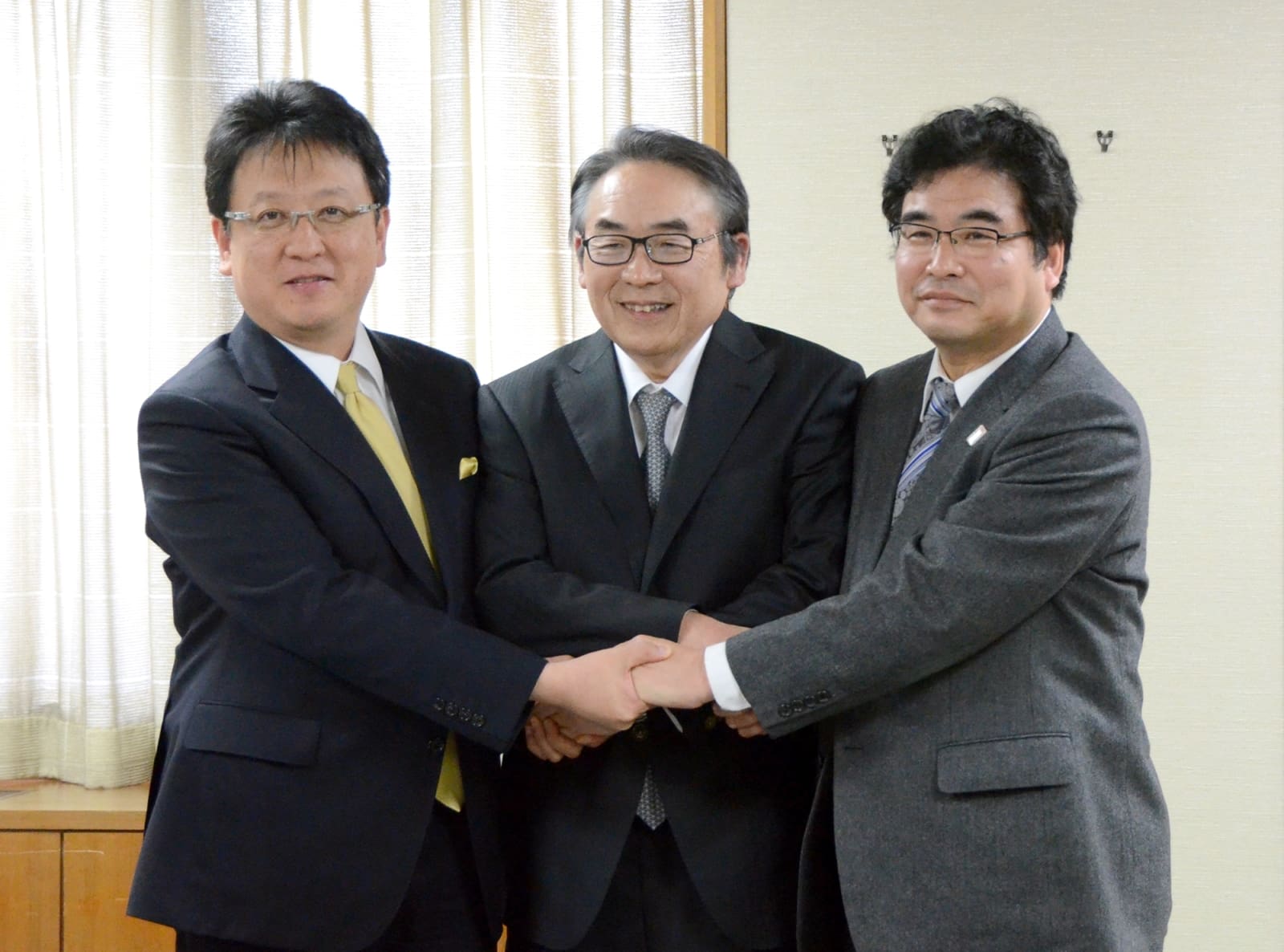 熊本市と立地協定を結んだヤマエ久野の網田日出人社長（中央）。左は大西一史市長、右は奥薗惣幸・県商工観光労働部長＝８日、同市役所